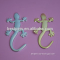 silver and gold Gecko metal plates